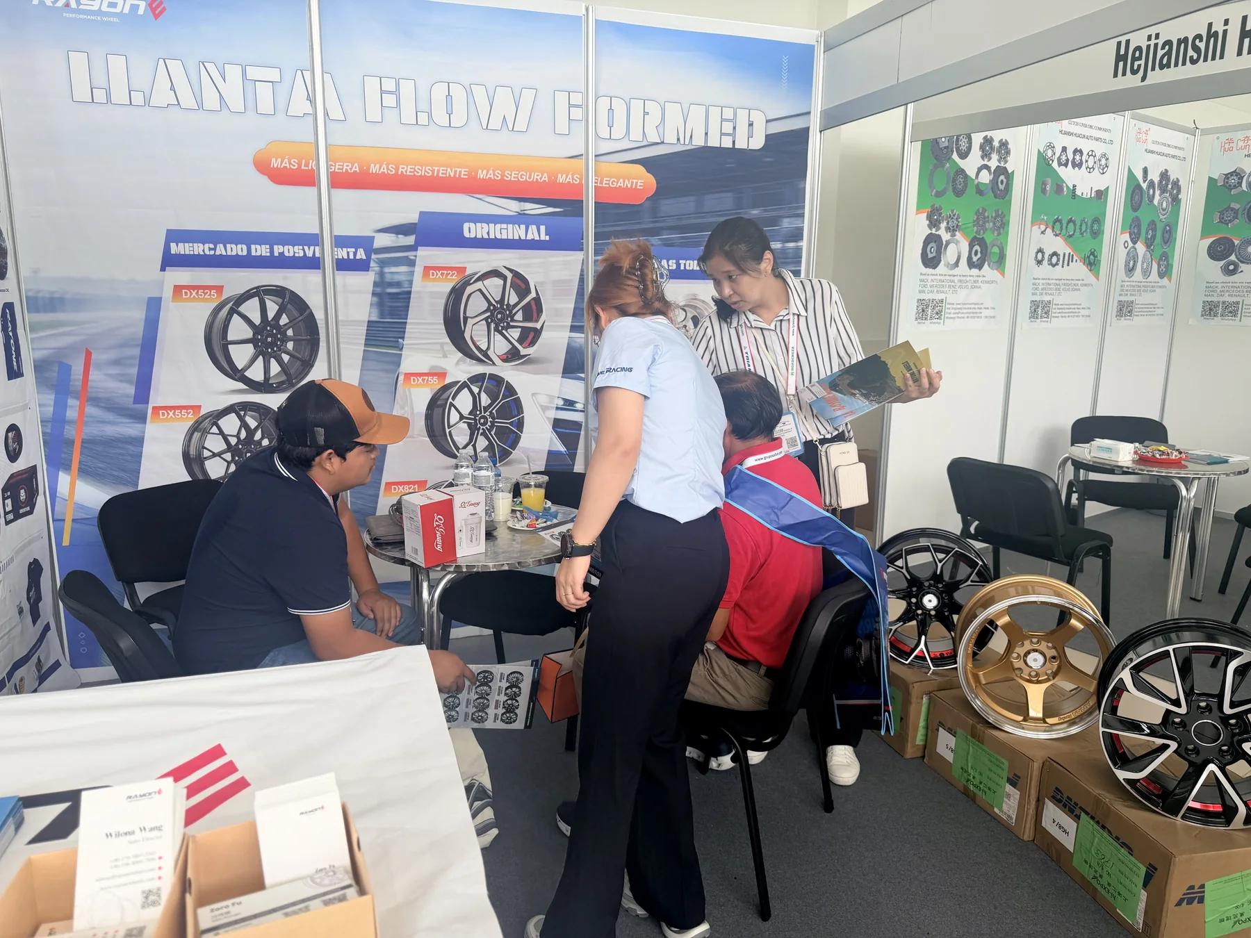 RAYONE representative discussing wheel products with visitors at the Panama expo