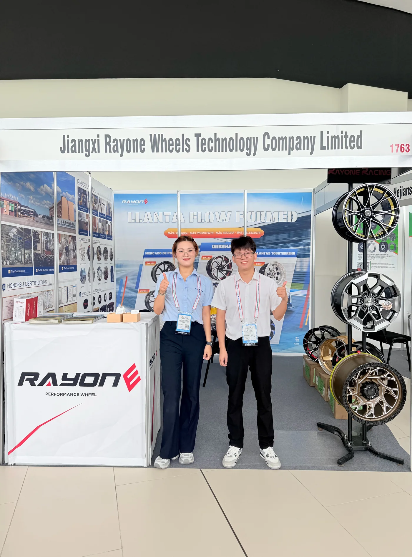 RAYONE team members at Booth 1763 with flow formed and off-road wheel displays